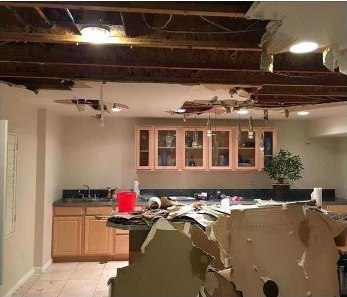 Image of a collapsed ceiling due to water damage 